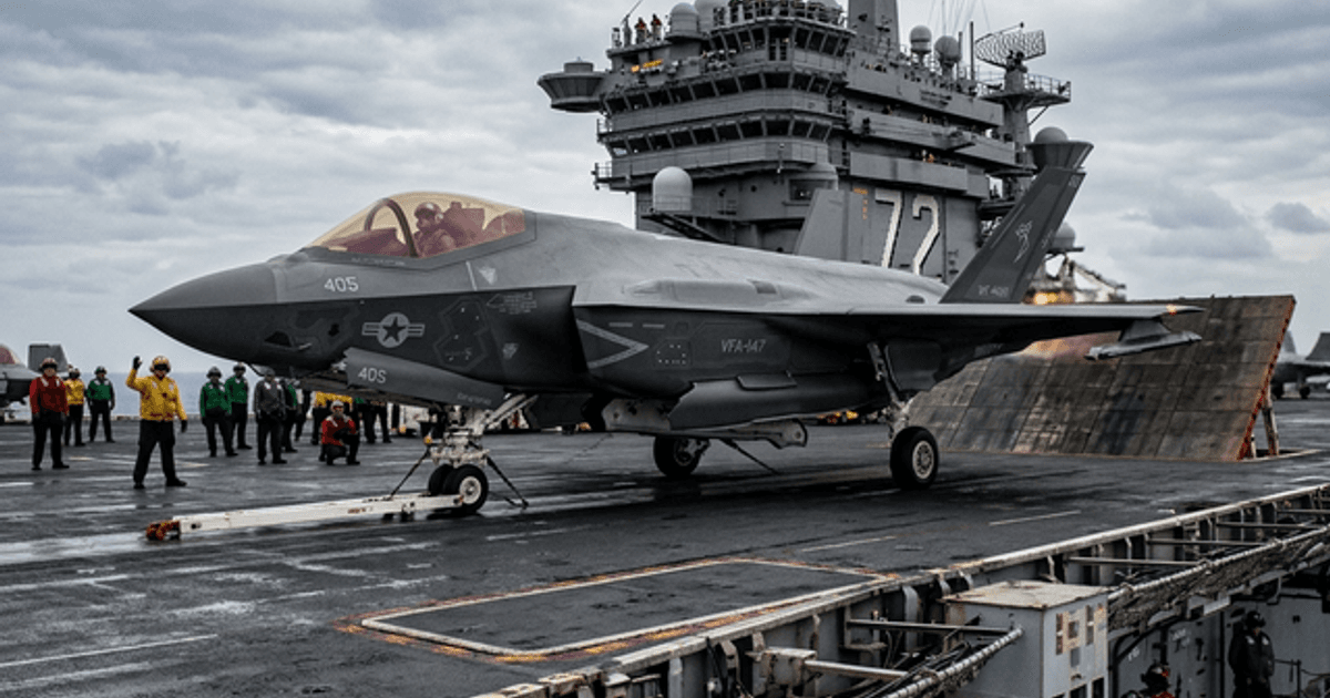 Fighter jet in a defense manufacturing facility during a production surge